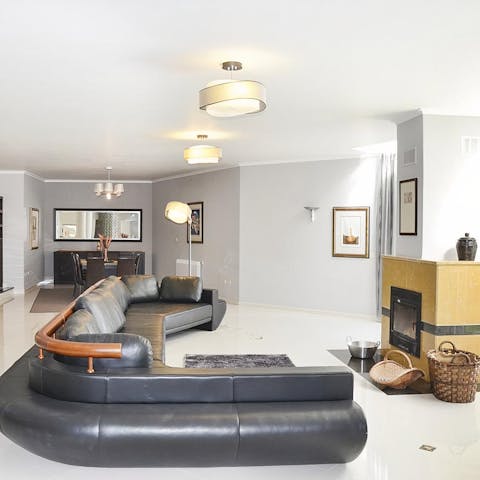 Stretch out on the vast leather sofa in front of the fire