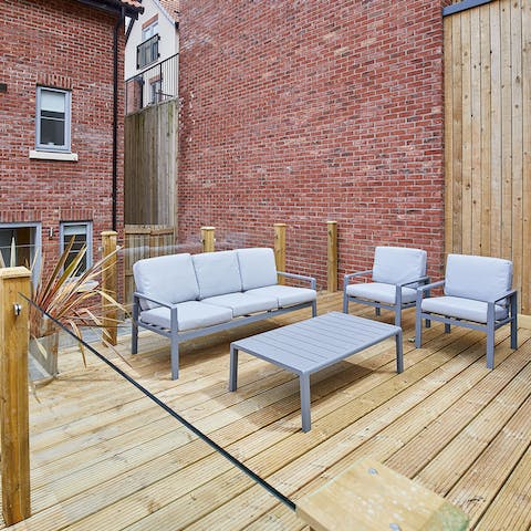 Sit out on the raised patio in the garden, catching up and sipping drinks