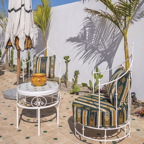 Enjoy a glass of ginja on one of the comfy outdoor seats