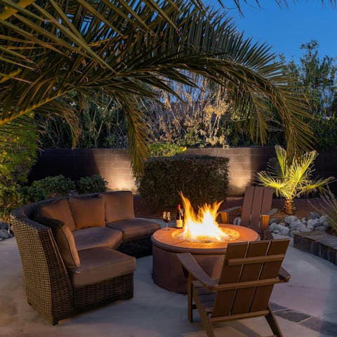 Share your best stories around the atmospheric fire pit lounge
