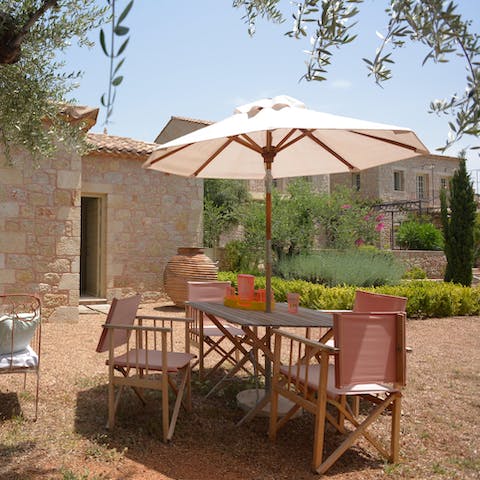 Enjoy a languorous lunch out in the home's verdant garden