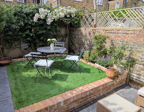 Unwind with a tipple in the sunny small garden