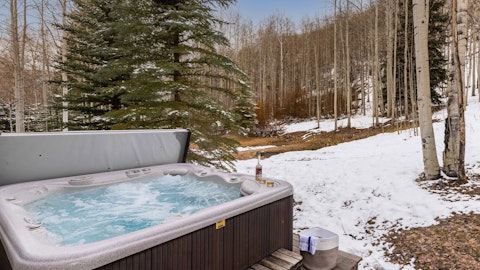 Soak in the private hot tub beneath the surrounding aspen trees
