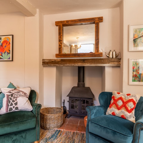 Curl up with a book on the comfy armchair by the traditional fireplace