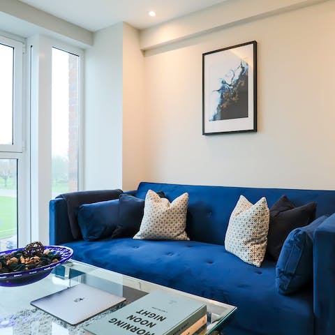 Curl up with a good book on the comfy sofa in the living room, a perfect place to also enjoy a movie night
