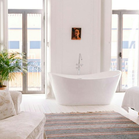 Treat yourself to a long soak in the bedroom's private bath tub