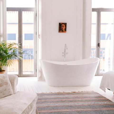 Treat yourself to a long soak in the bedroom's private bath tub