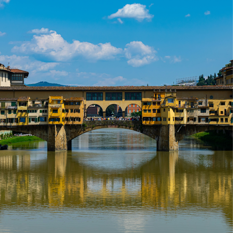 Visit Ponte Vecchio bridge and its surrounding shops, just a short walk away