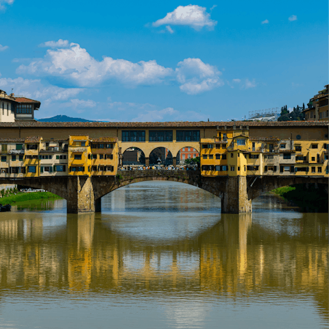 Visit Ponte Vecchio bridge and its surrounding shops, just a short walk away