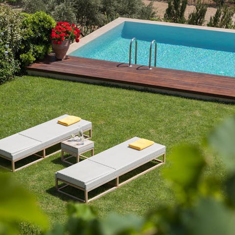 Stretch out in the sun beside the private pool