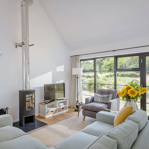 Relax by the contemporary log burner with a G&T in hand