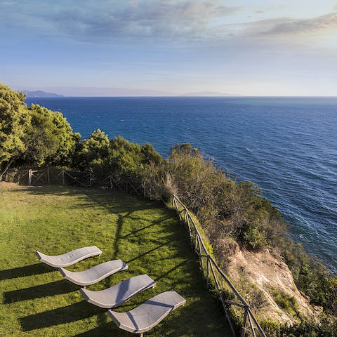 Watch the tide roll in as you lie back on a lounger