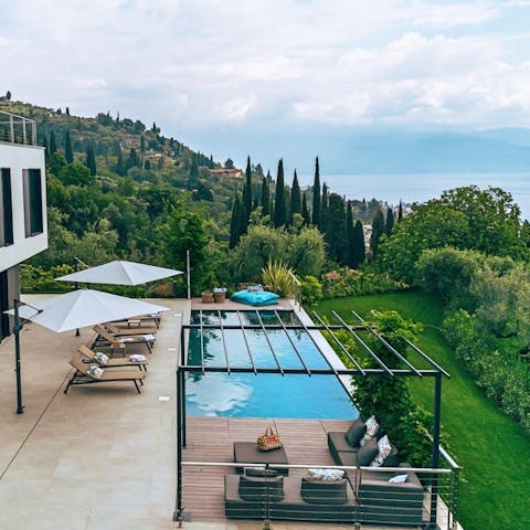 Lounge around the pool, complete with a lakeside view