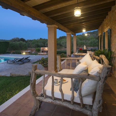 Watch the sunset from the terrace with a glass of local wine