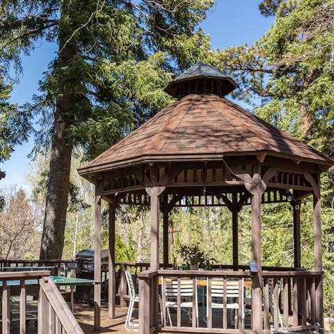 Dine in the shade of the gazebo in the pine trees