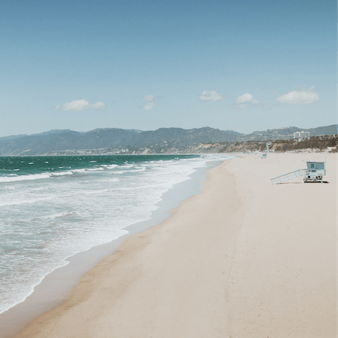 Sink the sand into your toes on Santa Monica Beach, a nineteen minute drive away