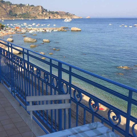 Relax with a glass of wine on your private balcony overlooking the sea