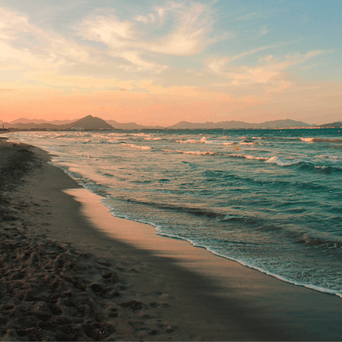 Enjoy a stroll along the sands of Platja de l'Arenal at sunset, it's a short walk away