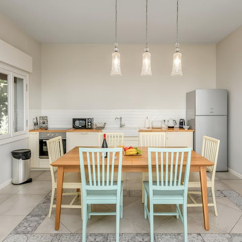 Host group meals in the open-plan kitchen and dining space