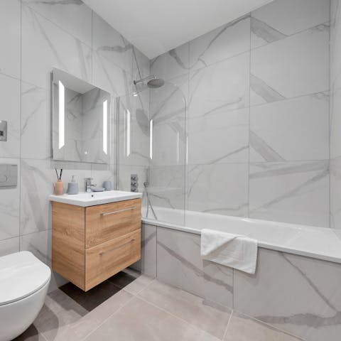 Treat yourself to a relaxing bubble bath in the marble tub