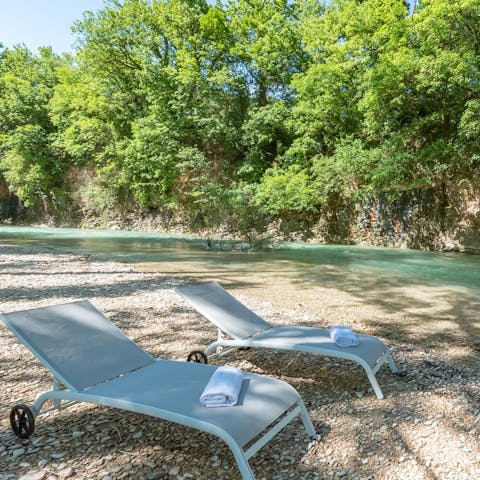 Stroll down to your private riverside beach