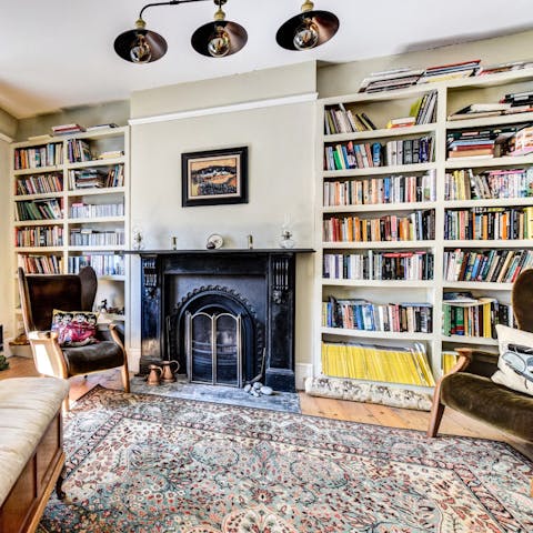 Lose yourself in a good book by the welcoming fireplace