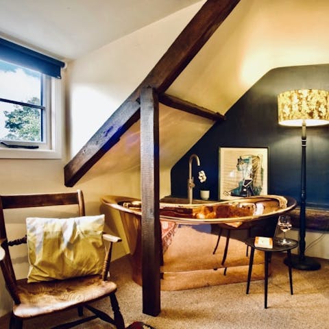 Indulge in a soak session in your freestanding copper bathtub