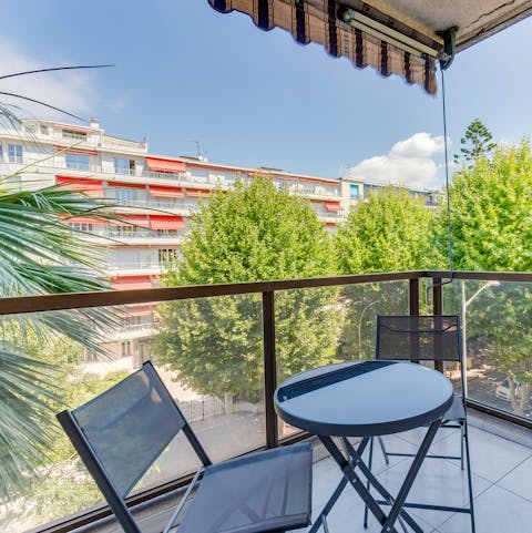 Enjoy a glass of French wine on the balcony