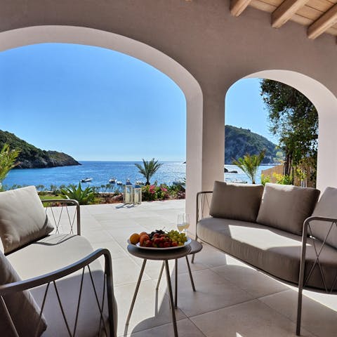 Enjoy fresh fruit and coffee looking out across the sea