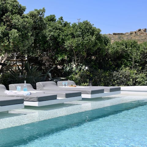 Lounge by the private pool while sipping a cold cocktail