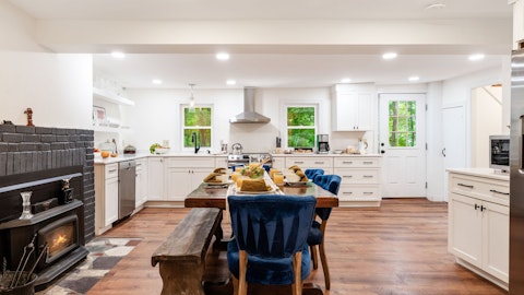 Cook and eat together beside a warming log stove