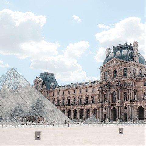 Spend an afternoon exploring the Louvre Museum, a short walk away