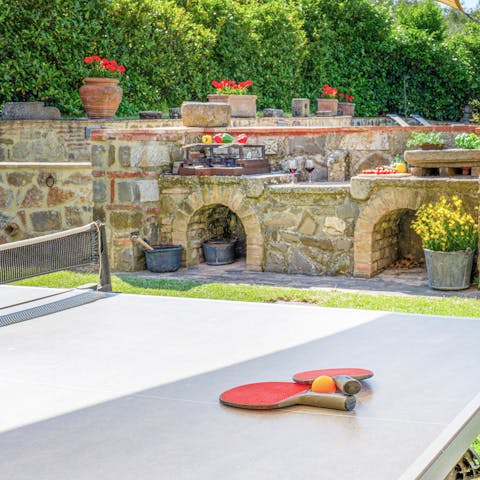 Play a friendly game of outdoor ping pong