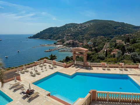 Stretch out beside the communal pool as the Mediterranean glitters below