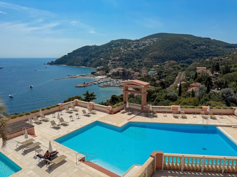 Stretch out beside the communal pool as the Mediterranean glitters below