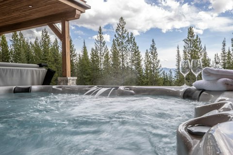 Soak in the private hot tub with pine forest stretching out ahead