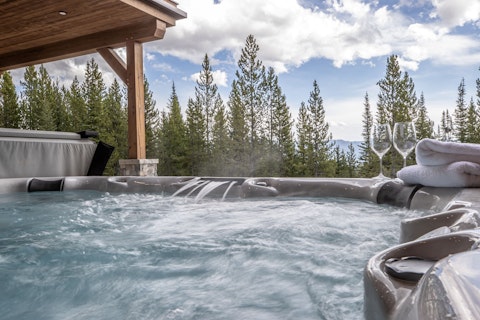 Soak in the private hot tub with pine forest stretching out ahead