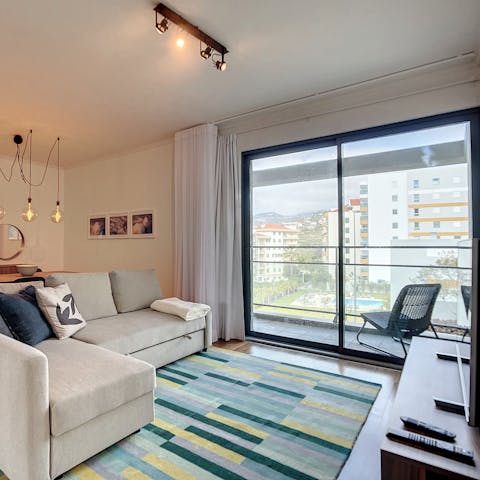 Enjoy natural sunlight from indoors with large glass doors leading to the balcony