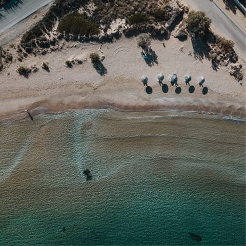 Feel the sand between your toes at Xifara beach, a short walk from home