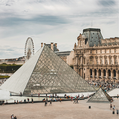 Wander over the Pont des Arts to the Louvre Museum