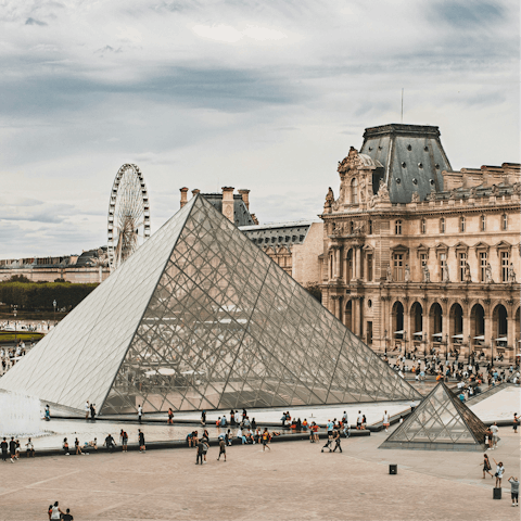 Wander over the Pont des Arts to the Louvre Museum