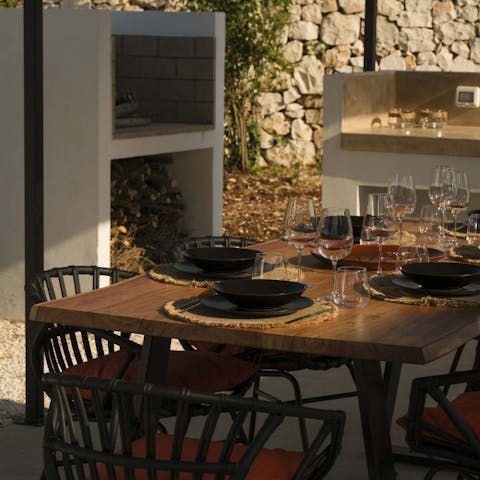 Set up for lavish outdoor meals in the full summer kitchen complete with barbecue and induction hobs