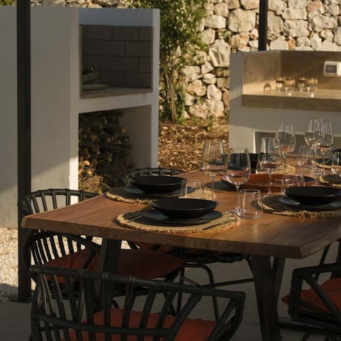 Set up for lavish outdoor meals in the full summer kitchen complete with barbecue and induction hobs