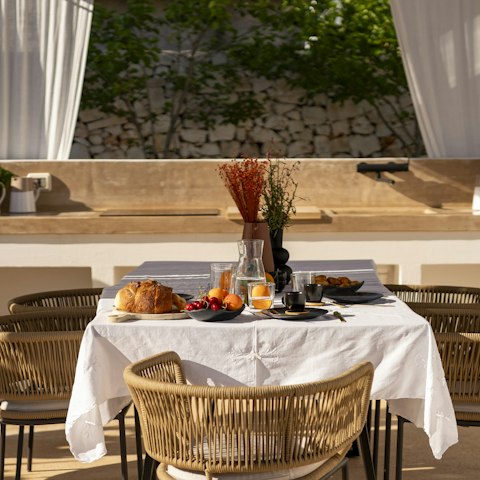 Set up for lavish outdoor meals in the full summer kitchen complete with barbecue and induction hobs