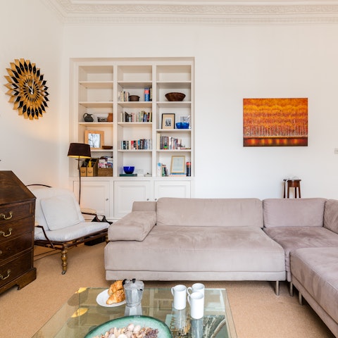 Relax in the living room with a cup of Earl Grey and one of the books on the shelves