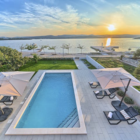 Step from your swimming pool straight onto the beach