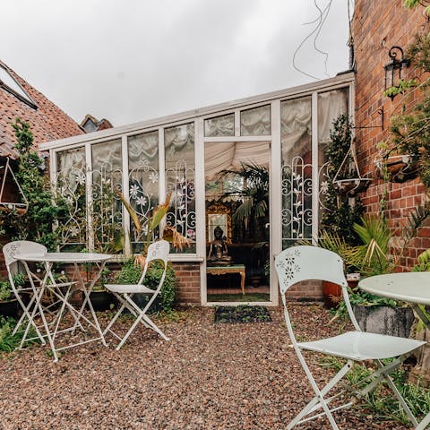 Enjoy your alfresco wine in the billowing garden with pretty patio furniture