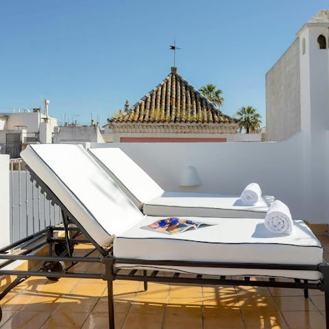 Stretch out on the sun deck with views across of the Giralda