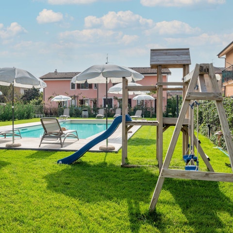 Take a dip in the pool while the kids enjoy their playground