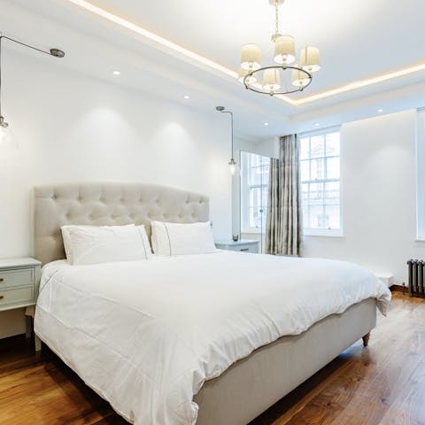 Wake up refreshed in the sleek, serene bedroom